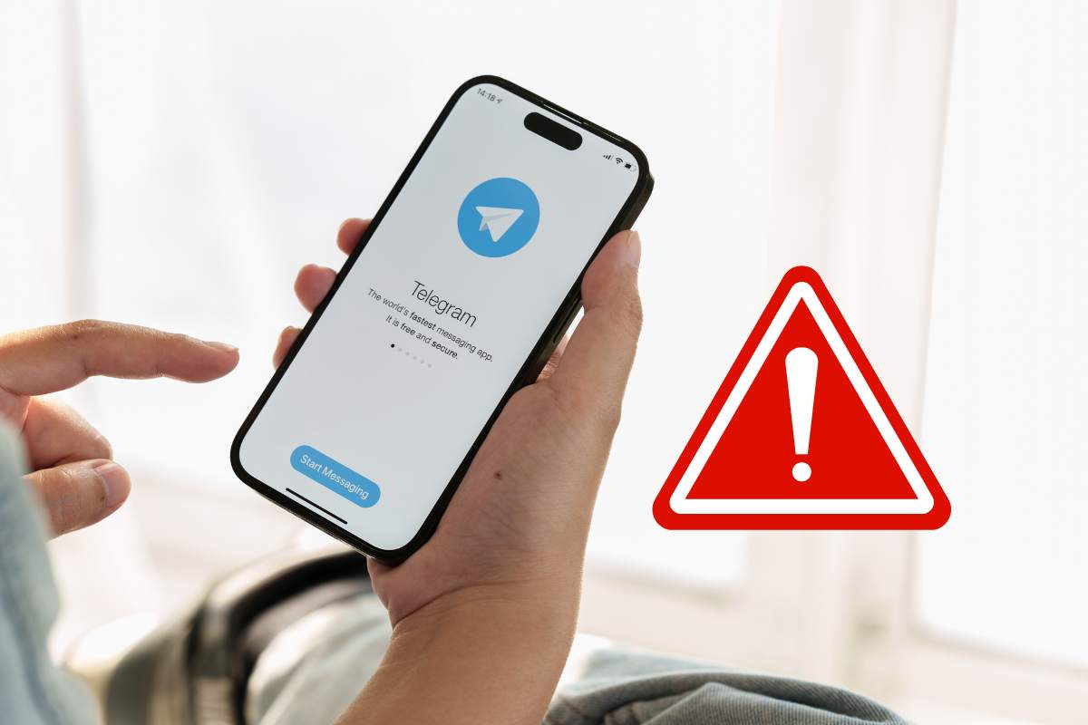 telegram smartphone in mano simbolo pericolo